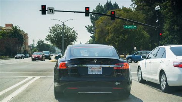 How does one keep trains from slowing down while waiting for a green signal?